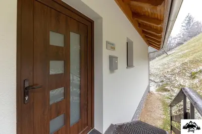 a wooden door on the side of a building at Brlog in Zgornje Gorje