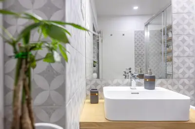 a bathroom with a white sink and a mirror at Old Quarter Residence in Ljubljana