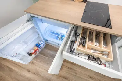 an open drawer in a kitchen with a counter at Old Quarter Residence in Ljubljana