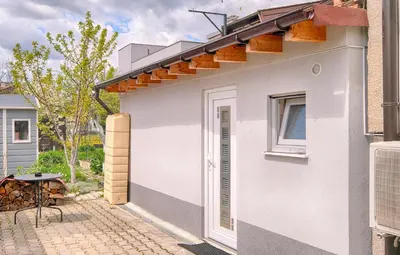 a white house with a solarium on the side of it at Studio Southwest 3 with AirCon & FREE Parking in Ljubljana