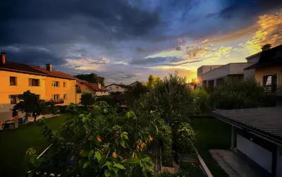 a view of a yard with a sunset in the background at Studio Southwest 3 with AirCon & FREE Parking in Ljubljana