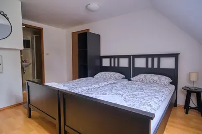 a bedroom with a large bed in a room at Samostan Mekinje in Kamnik