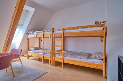 a bedroom with two bunk beds in a room at Samostan Mekinje in Kamnik
