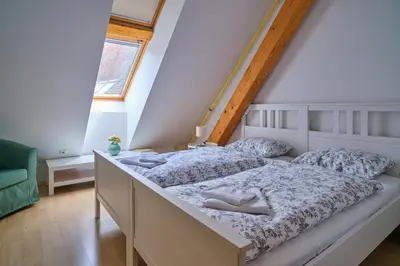 a bedroom with two beds and a window at Samostan Mekinje in Kamnik