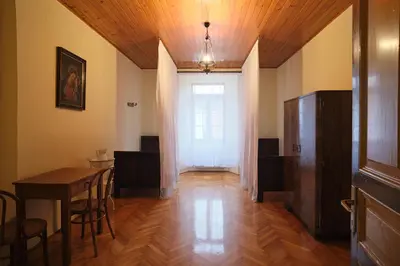 a room with a table and chairs and a window at Samostan Mekinje in Kamnik