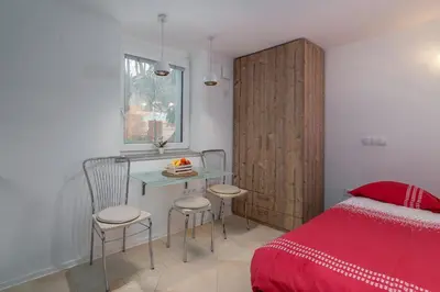 a bedroom with a bed and a table and chairs at Studio Sergio in Bled