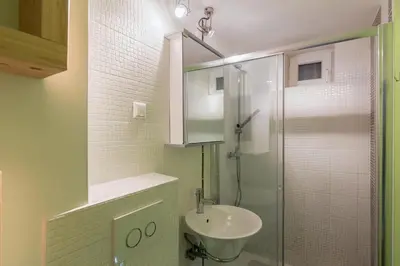 a bathroom with a sink and a glass shower at Studio Sergio in Bled