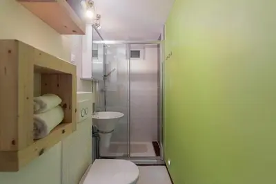 a bathroom with a shower and a toilet and a sink at Studio Sergio in Bled