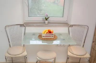 a glass table with two chairs and a bowl of fruit at Studio Sergio in Bled