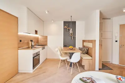 a kitchen and dining room with a table and chairs at Cozy Apartment in the heart of Kranjska Gora in Kranjska Gora