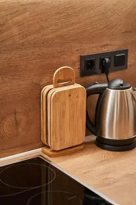 a wooden container sitting on a counter next to a tea kettle at Cozy Apartment in the heart of Kranjska Gora in Kranjska Gora