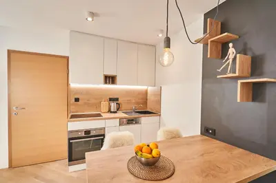 a kitchen with a table with a bowl of fruit on it at Cozy Apartment in the heart of Kranjska Gora in Kranjska Gora