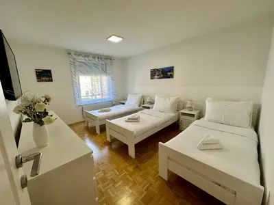 a living room with two beds and a couch at Clara Ljubljana Apartment in Ljubljana