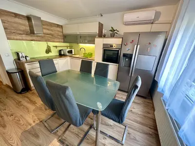 a kitchen with a glass table and chairs in it at Clara Ljubljana Apartment in Ljubljana