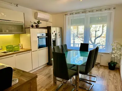 a kitchen with a table and chairs in a room at Clara Ljubljana Apartment in Ljubljana