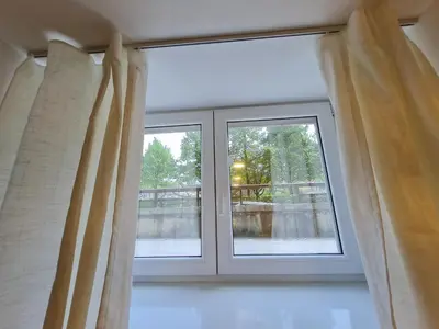 a large window with curtains in a room at Studio Apartment Gea Tour As Ljubljana in Ljubljana