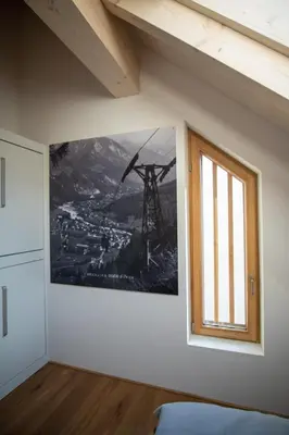 a room with a window and a picture on the wall at Apartment Špica - Private parking in Kranjska Gora