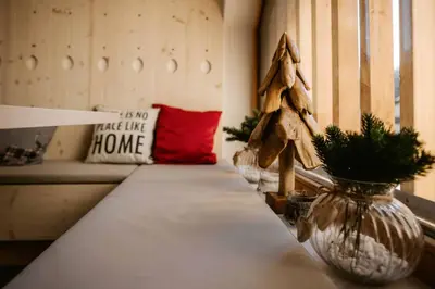 a room with a table with a christmas tree in a vase at Apartment Špica - Private parking in Kranjska Gora