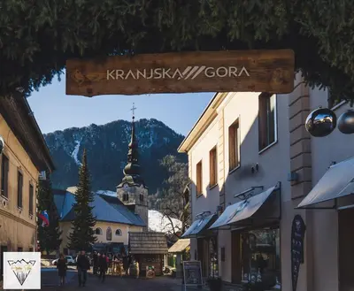 a street sign in a town with a church at Apartment Špica - Private parking in Kranjska Gora