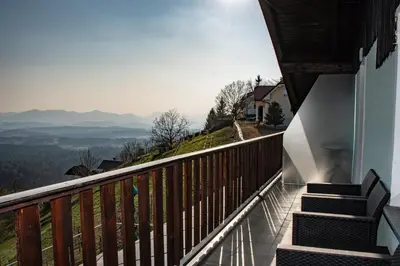 a balcony with stairs and a view of the mountains at Vineyard Paradise Senica in Dramlje