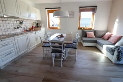a kitchen and living room with a table and a couch at Bohinj - Old Village House in Bohinj