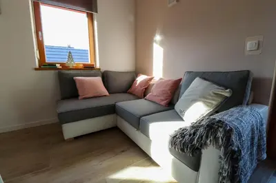 a living room with a couch and a window at Bohinj - Old Village House in Bohinj