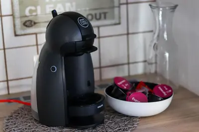a black mixer sitting on a counter next to a bowl at Bohinj - Old Village House in Bohinj