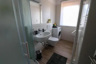 a bathroom with a sink and a toilet and a mirror at Bohinj - Old Village House in Bohinj