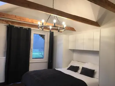 a bedroom with a bed and a chandelier at Kasita Bled Apartments in Bled