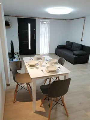 a white table and chairs in a living room at Kasita Bled Apartments in Bled