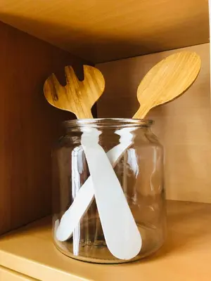 a jar with wooden utensils sitting on a shelf at APARTMA DOMENIKA in Ptuj