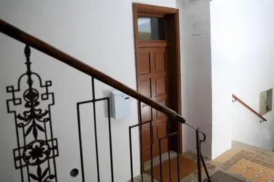 a stairway with a wooden door and a stair railing at APARTMA DOMENIKA in Ptuj