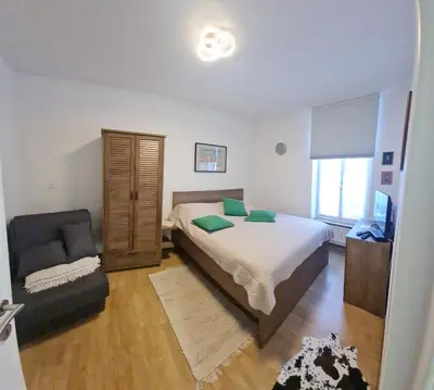 a bedroom with a bed and a chair in it at APARTMA DOMENIKA in Ptuj