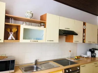 a kitchen with white cabinets and a sink at APARTMA DOMENIKA in Ptuj
