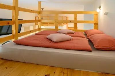 a large bed with two pillows on top of it at APARTMA RANČ LUŽE in Kranj