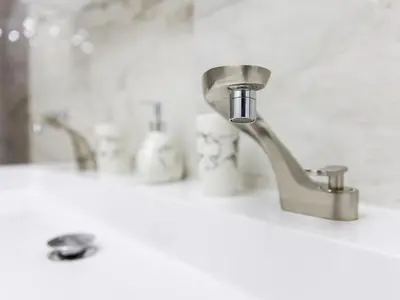 a bathroom sink with two faucets on a counter at Reset Apartments in Kranjska Gora