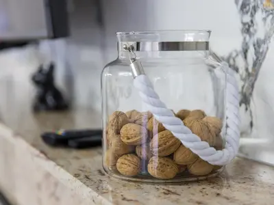 a glass jar filled with peanuts sitting on a counter at Reset Apartments in Kranjska Gora