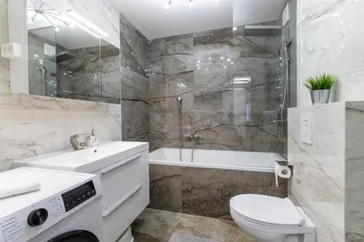 a bathroom with a sink and a toilet and a shower at Reset Apartments in Kranjska Gora