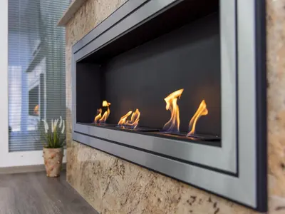 a fireplace with flames in it on a wall at Reset Apartments in Kranjska Gora