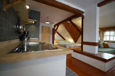 a kitchen with a sink and a room with two beds at Martin's Hidden Garden in Ljubljana