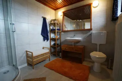 a bathroom with a toilet and a sink and a shower at Martin's Hidden Garden in Ljubljana