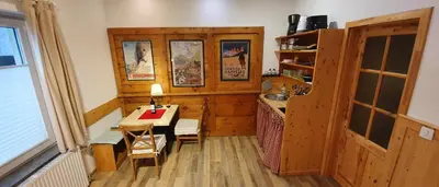 a small room with a table and a kitchen at Martin's Hidden Garden in Ljubljana