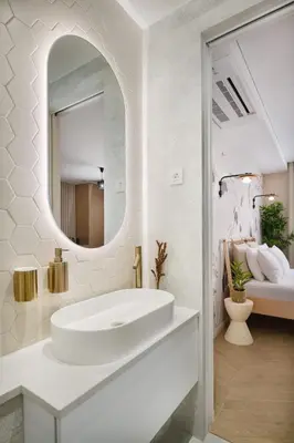 a white bathroom with a sink and a mirror at Eagle's Nest Ljubljana in Ljubljana