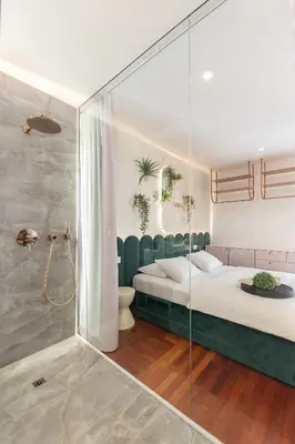 a bedroom with a bed and a glass shower at Eagle's Nest Ljubljana in Ljubljana