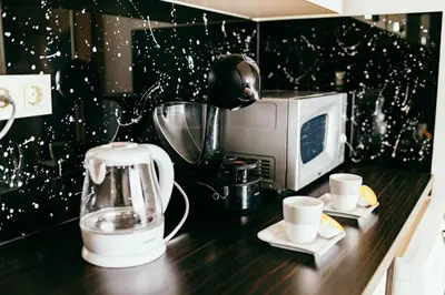 a kitchen counter with a blender and a microwave at HERMES APARTMENT & 2 free garage secured parkings in Ljubljana