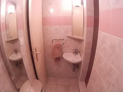 a small bathroom with a toilet and a sink at The Cave in Ljubljana