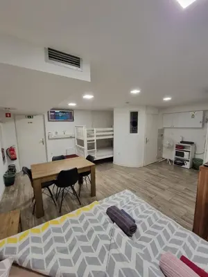 a room with a desk and a table and a bed at The Cave in Ljubljana
