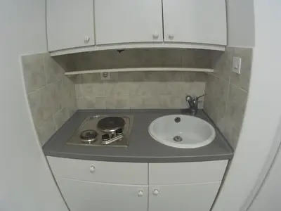 a small kitchen with a sink and a stove at The Cave in Ljubljana