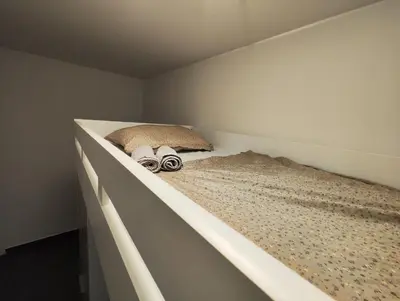 a bed in a room with two shoes on it at Goriška Apartments in Ajdovščina