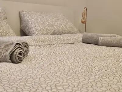 a bed with two pillows on it with at Goriška Apartments in Ajdovščina